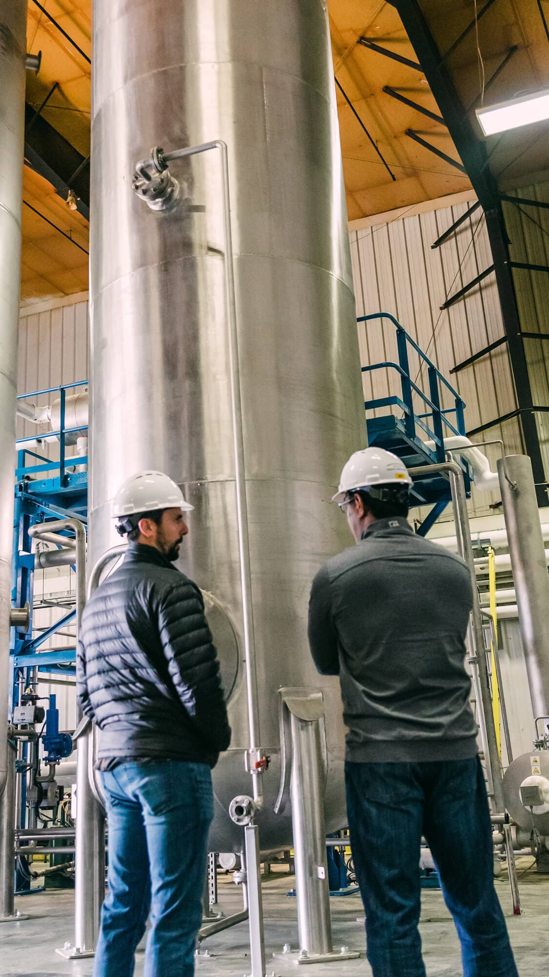 Two brewers stand side by side