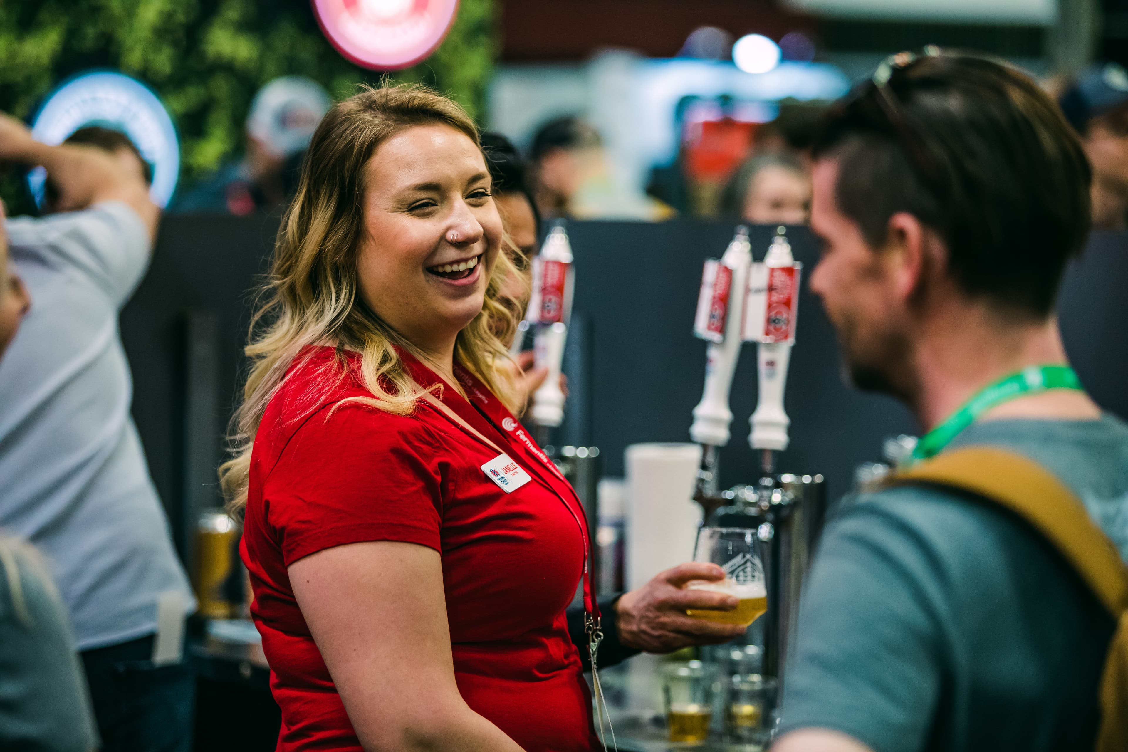 Yakima Chief Hops employee smiling at customer at industry event