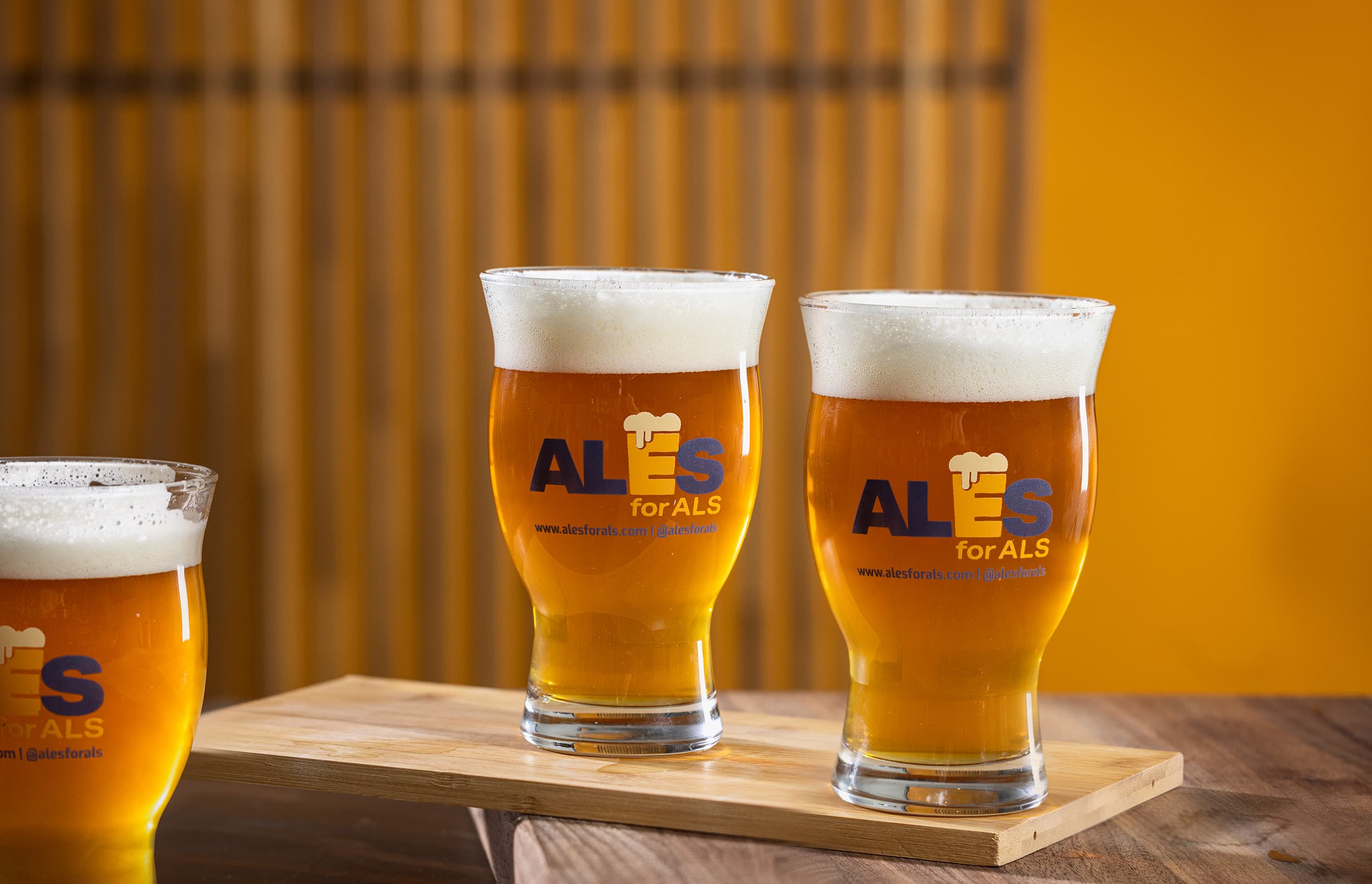 Three pint glasses full of beer sitting on table