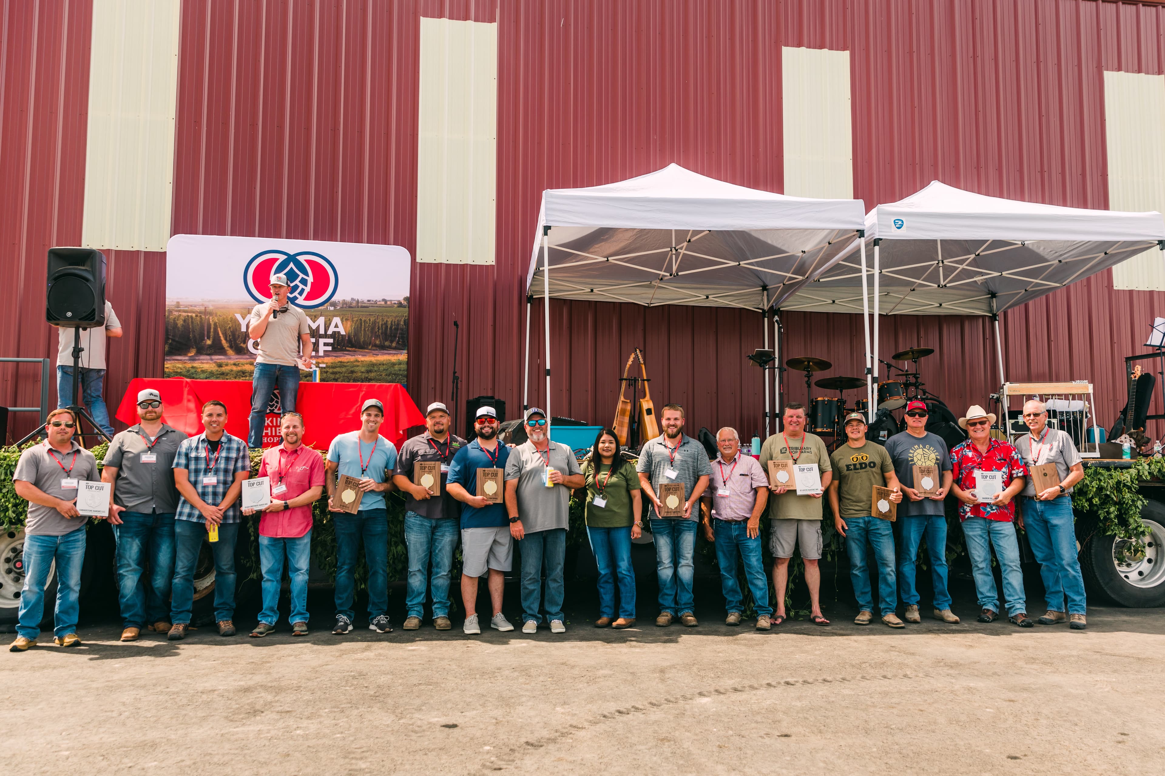 Group of farmers gathered and holding their Top Cut Award plaques