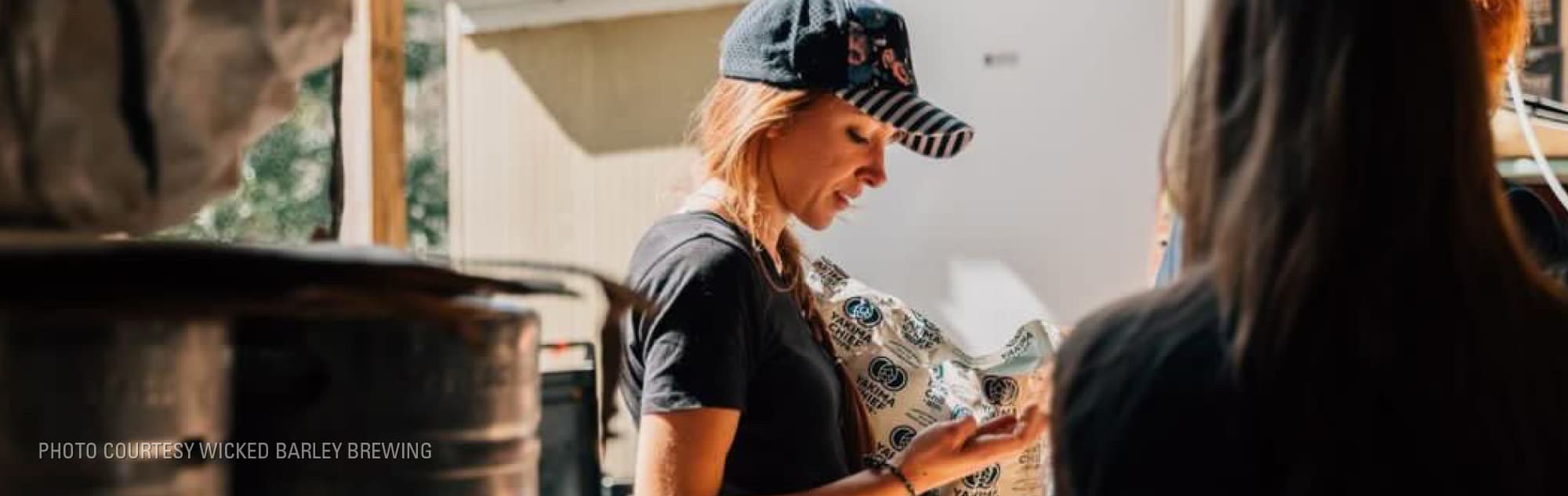 Brewer pours a bag of hops