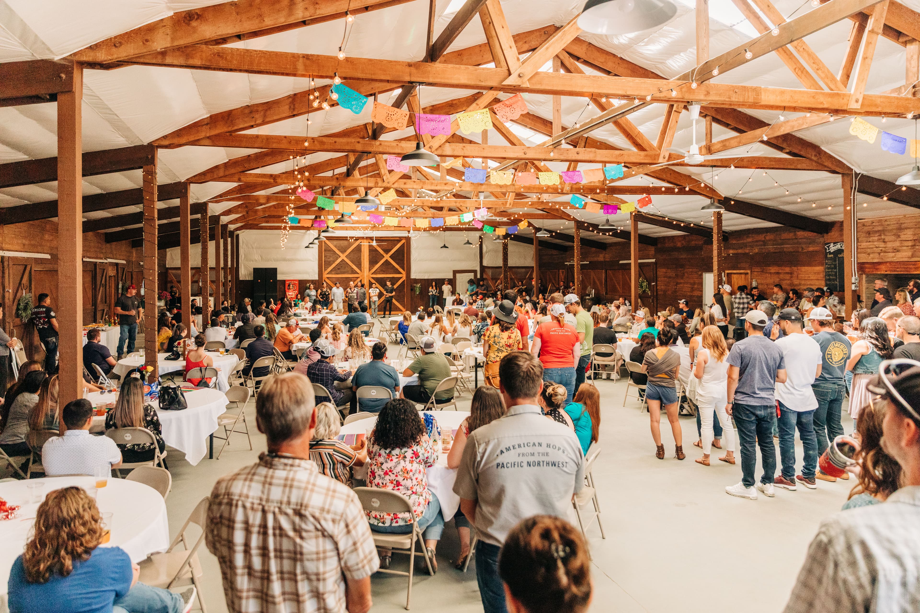 Barn-like indoor venue hosting a huge celebration
